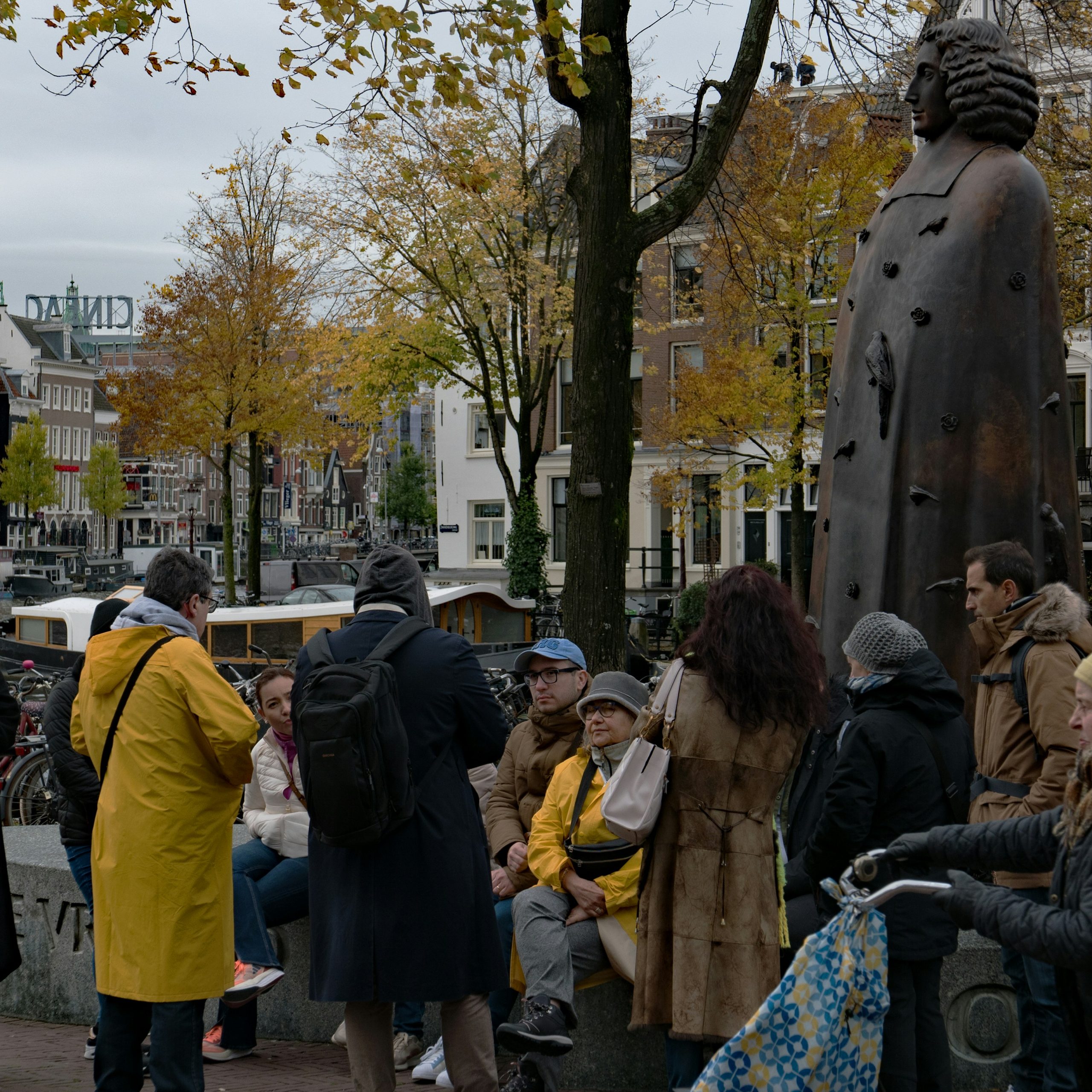 a group of people standing around a statue